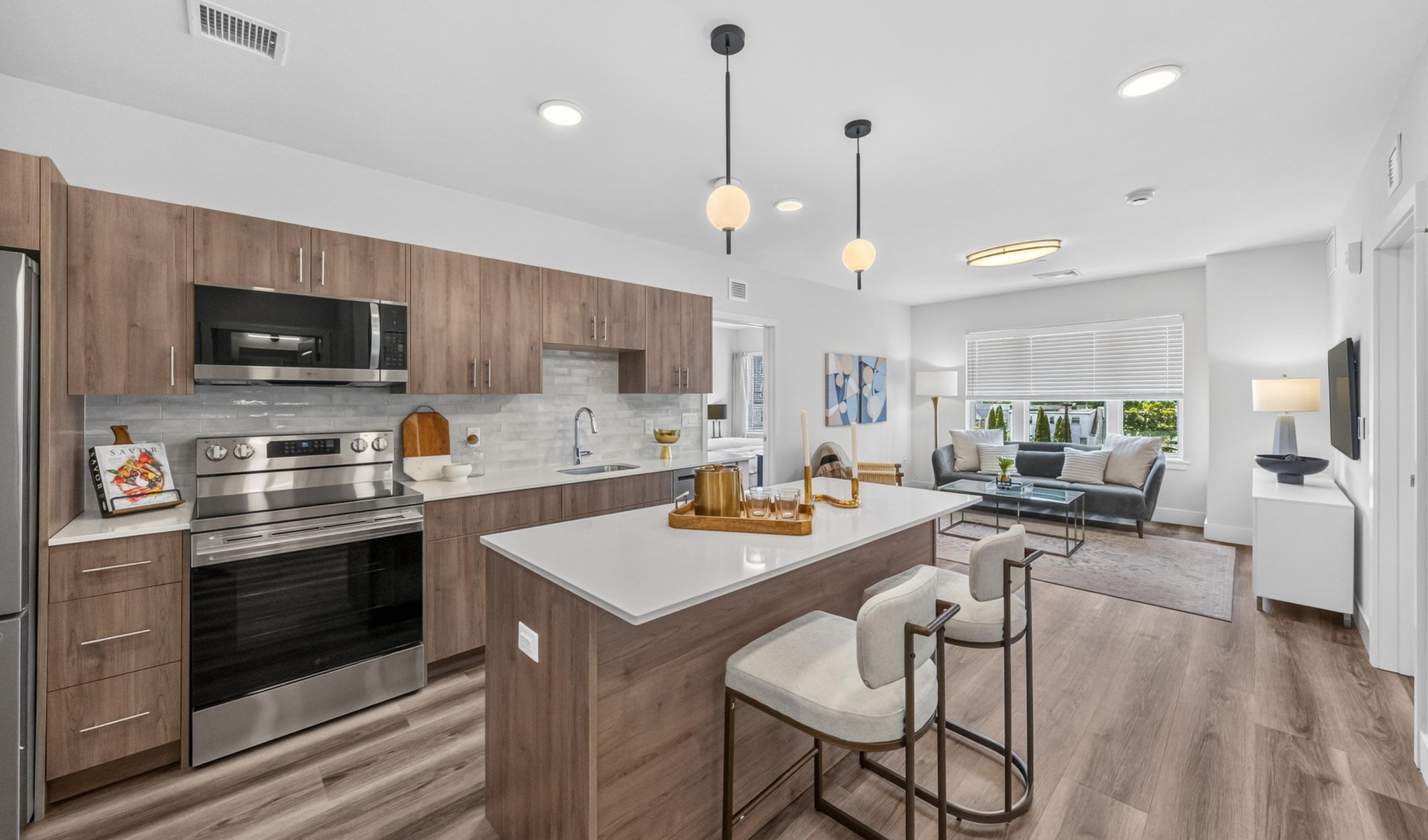 Apartment showing kitchen area and dining area looking into living room