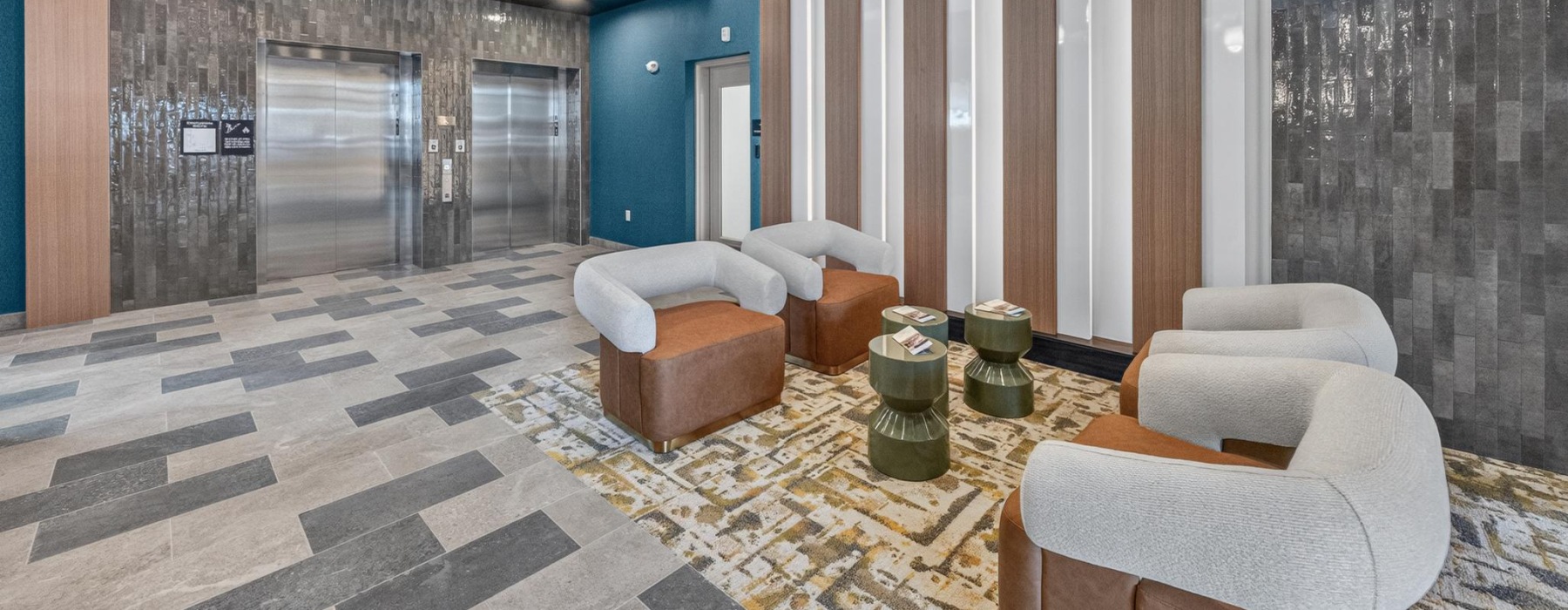 Lobby waiting area with seats and elevator