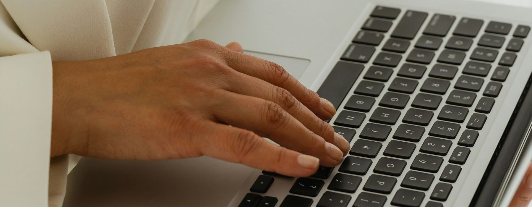 a woman typing on a keyboard