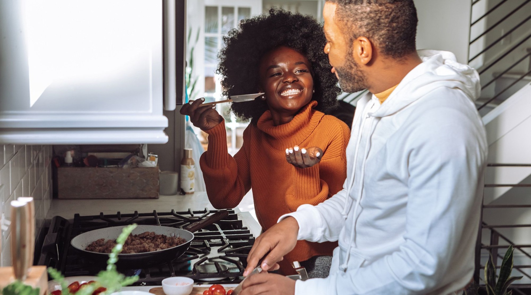 a couple in a kitchen